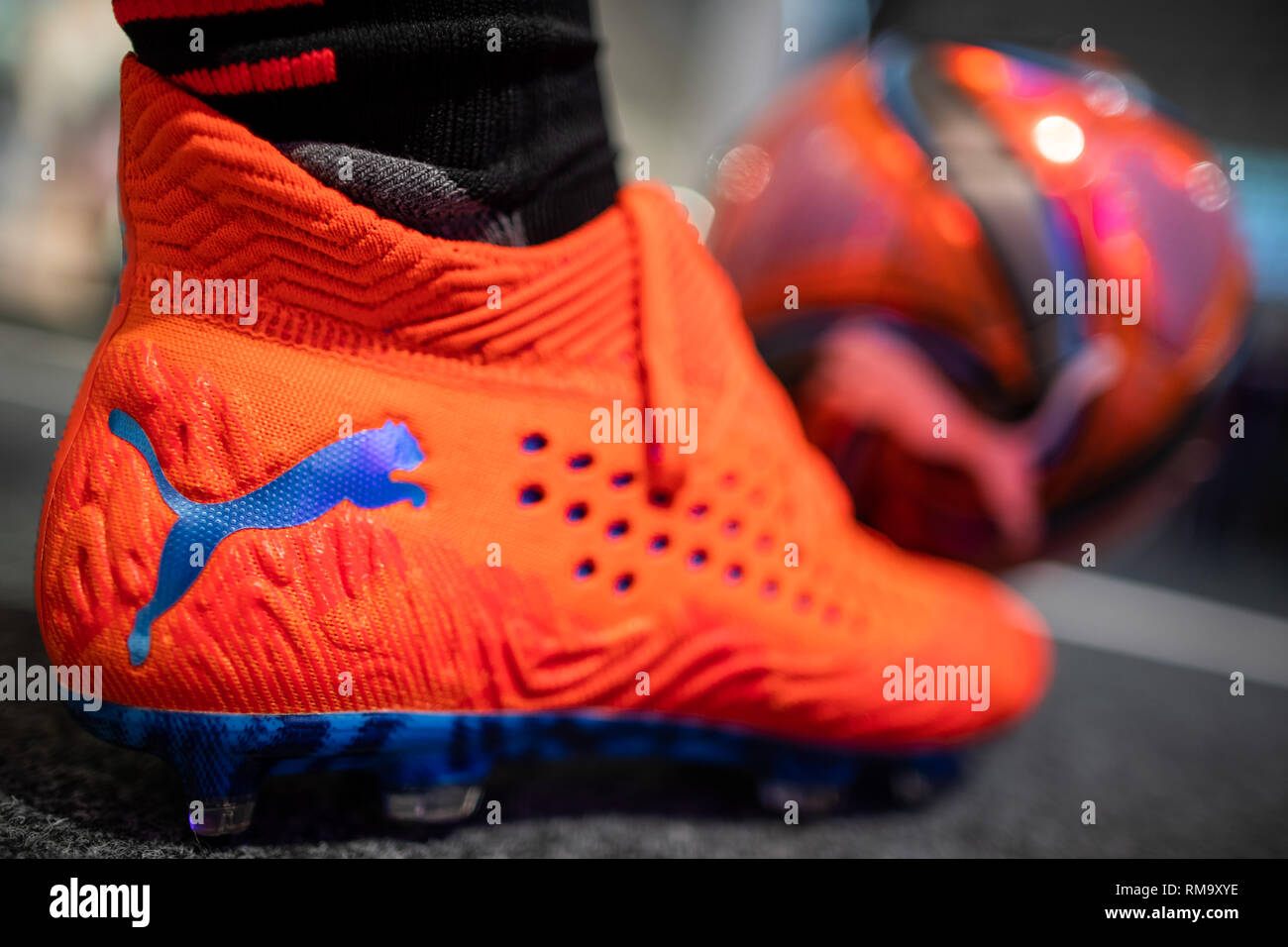 14 February 2019, Bavaria, Herzogenaurach: A football and a football boot  with the logo of the sports goods manufacturer Puma SE are exhibited in the  company. On 14 February, the sporting goods