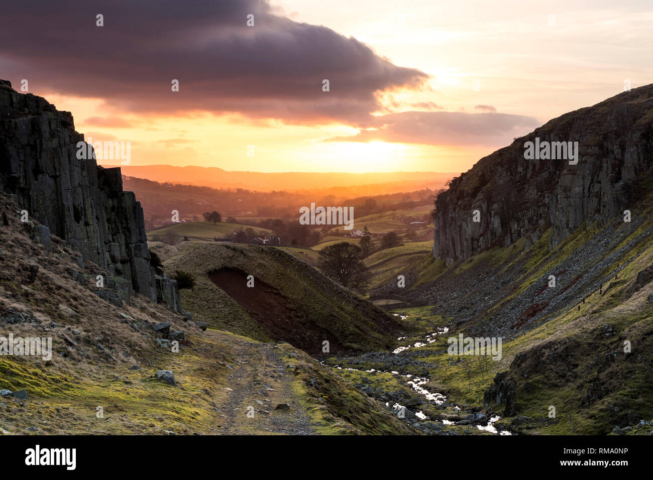 Holwick, Teesdale, County Durham, UK.  Thursday 14th February 2019. UK Weather.  It was a cool but colourful start to the day as the sun rose over the spectacular geology of Holwick Scars in the North Pennines this morning. Credit: David Forster/Alamy Live News Stock Photo