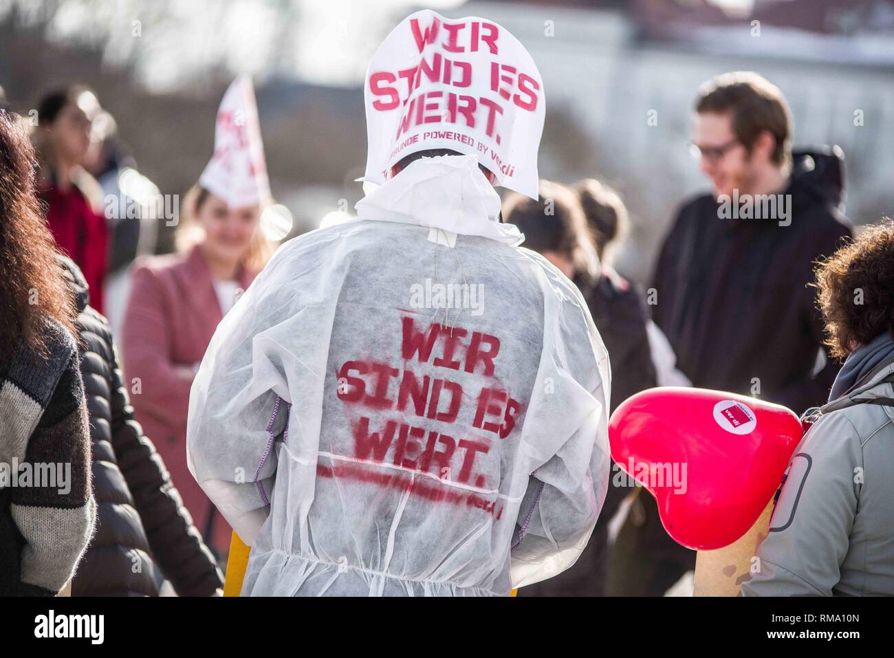 Munich, Bavaria, Germany. 14th Feb, 2019. ''We are worth it''- the motto of the Verdi union during strikes. To signify the failure of the second round of talks with employers, the German Verdi Ver.di labor union organized a 200  strong flashmob action at the famed Schloss Nymphenburg in Munich to kick off a new strike wave. Credit: ZUMA Press, Inc./Alamy Live News Stock Photo