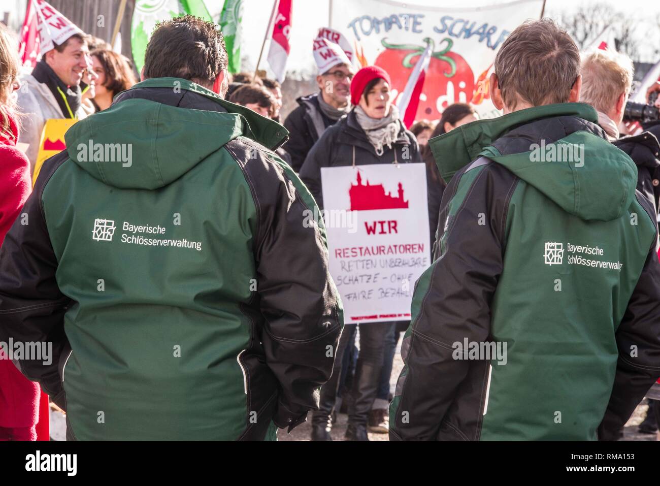 Munich, Bavaria, Germany. 14th Feb, 2019. Uniformed employees of the Bayerische Schloesserverwaltung were in attendance. To signify the failure of the second round of talks with employers, the German Verdi Ver.di labor union organized a 200  strong flashmob action at the famed Schloss Nymphenburg in Munich to kick off a new strike wave. Credit: ZUMA Press, Inc./Alamy Live News Stock Photo