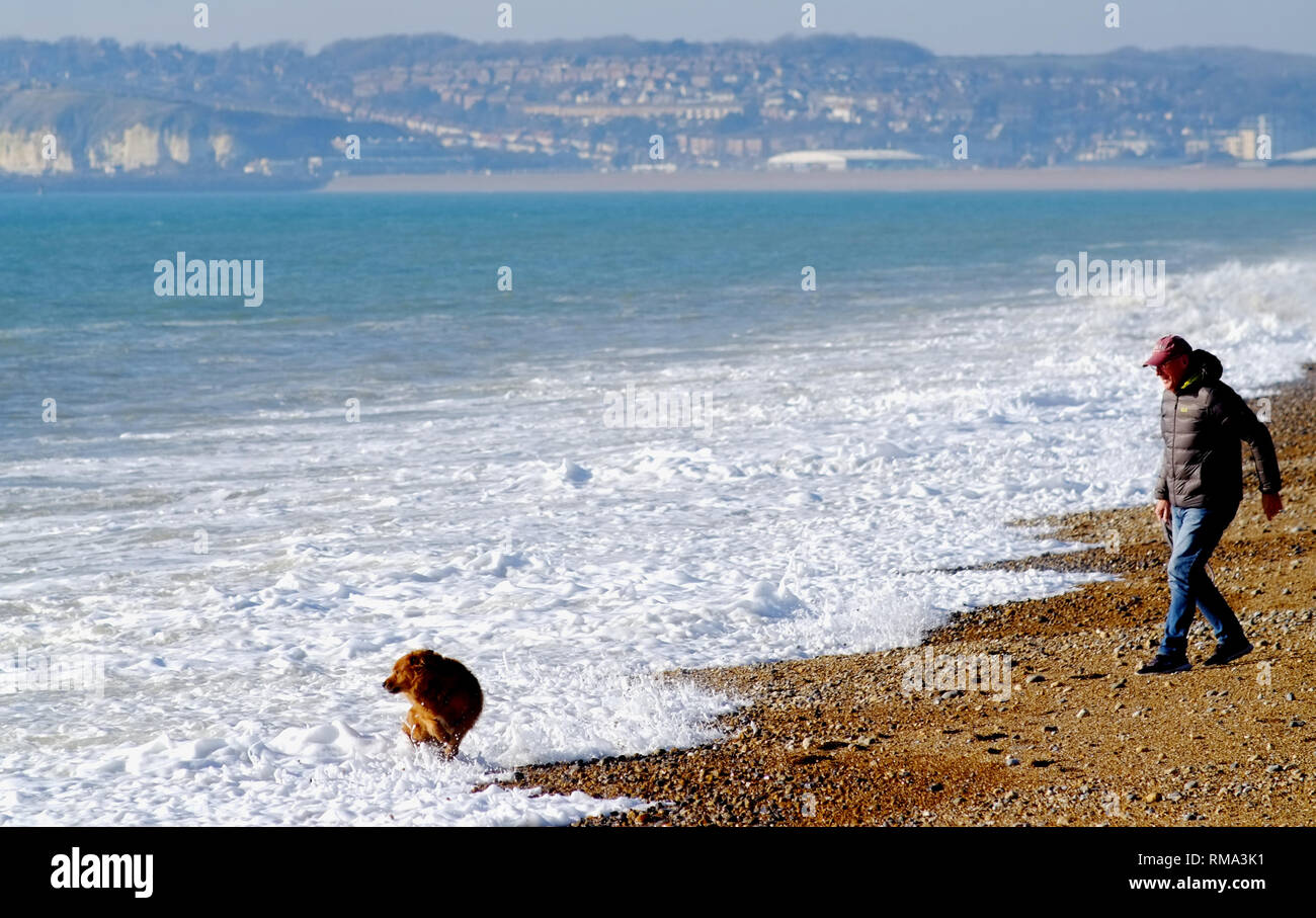 Seaford, East Sussex, UK. 14th Feb, 2019. People enjoying the bright warm sunshine on Seaford Beach. Credit: Peter Cripps/Alamy Live News Stock Photo
