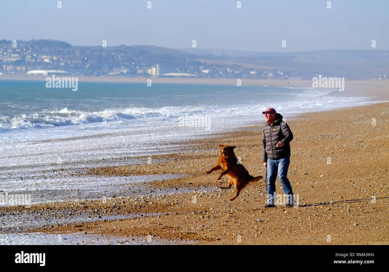 Seaford, East Sussex, UK. 14th Feb, 2019. People enjoying the bright warm sunshine on Seaford Beach. Credit: Peter Cripps/Alamy Live News Stock Photo