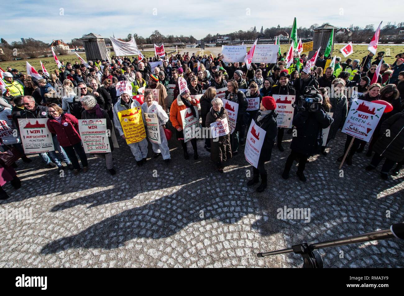 February 14, 2019 - Munich, Bavaria, Germany - To signify the failure of the second round of talks with employers, the German Verdi Ver.di labor union organized a 200+ strong flashmob action at the famed Schloss Nymphenburg in Munich to kick off a new strike wave.  The Union chose Castle Nymphenburg due to the pride and money Bavarian Ministerpresident Markus Soeder has invested into the castles of Bavaria, which in return have become major tourist attractions and income sources.  The union states that some of the money should be invested in the workers that that help keep these sites in opera Stock Photo