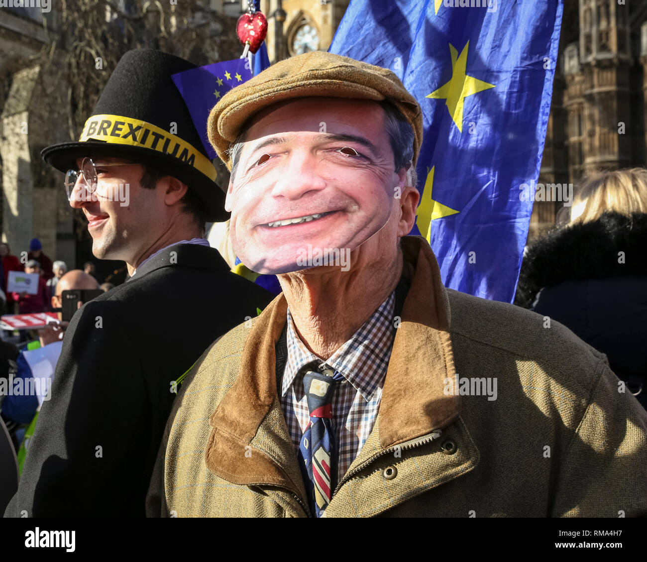 Westminster, London, UK. 14th Feb, 2019. Fake Farage visits the site. Remainers have organised a 'Fake Politicians' car, including Faux Bojo, Facob Rees-Mogg, a Fake Farage, a puppet of Theresa May, and a 'Devil'. They are joined by 'EU Supergirl' Madeleina Kay (left) Pro- and anti-Brexit protesters rally, wave flags and hold placards outside the Houses of Parliament and near the College Green media platforms in Westminster. Many have turned up in costumes and colourful outfits to get their message across. Credit: Imageplotter News and Sports/Alamy Live News Stock Photo