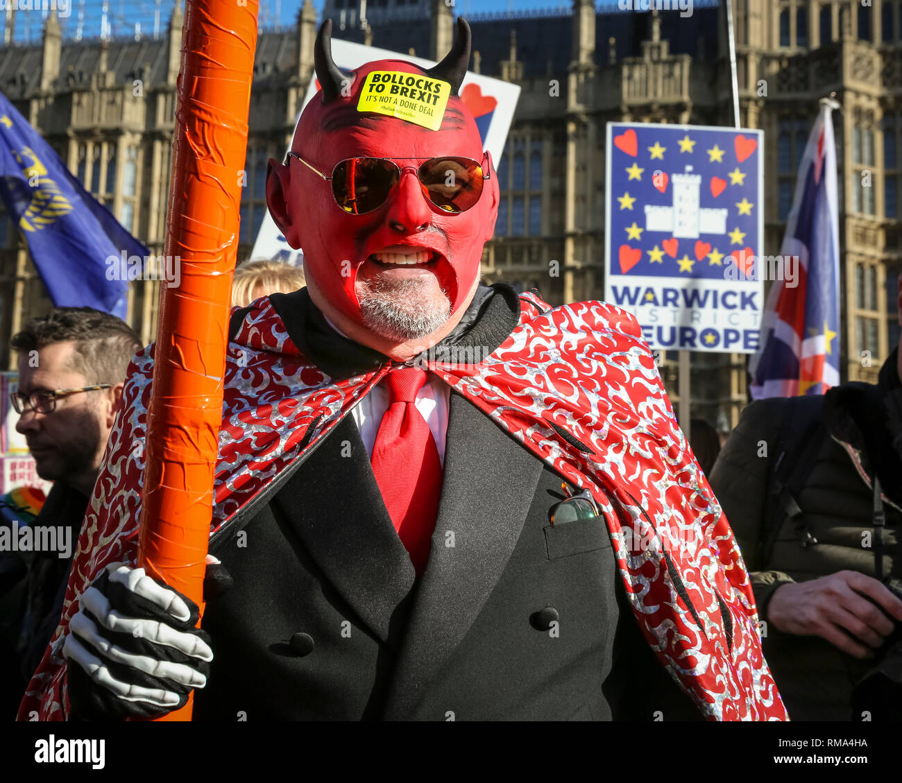 Westminster, London, UK. 14th Feb, 2019. The devil. Remainers have organised a 'Fake Politicians' car, including Faux Bojo, Facob Rees-Mogg, a Fake Farage, a puppet of Theresa May, and a 'Devil'. They are joined by 'EU Supergirl' Madeleina Kay (left) Pro- and anti-Brexit protesters rally, wave flags and hold placards outside the Houses of Parliament and near the College Green media platforms in Westminster. Many have turned up in costumes and colourful outfits to get their message across. Credit: Imageplotter News and Sports/Alamy Live News Stock Photo