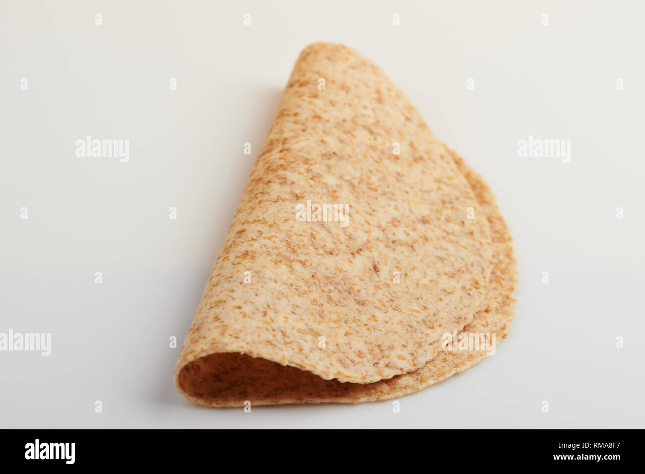 Empty folded tortilla isolated on white background angle view Stock Photo