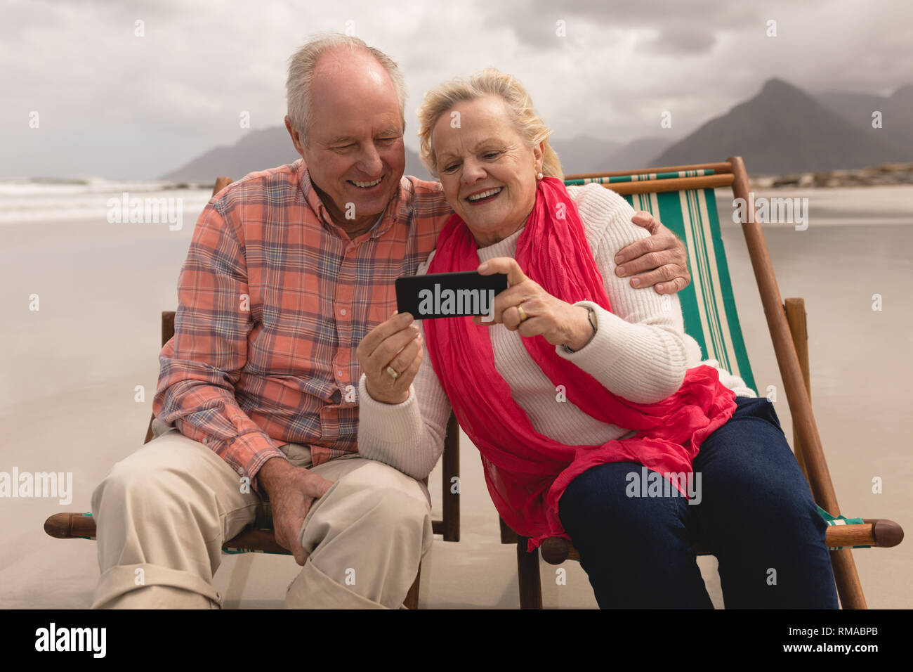 Senior couple using mobile phone Stock Photo