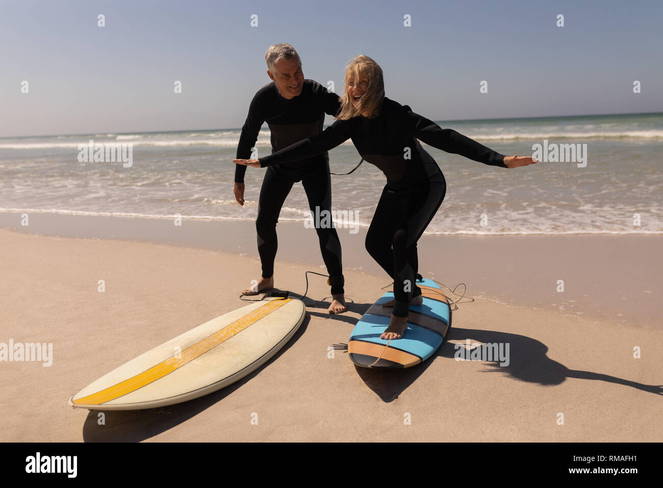 Surfer couple standing beach hi-res stock photography and images - Alamy
