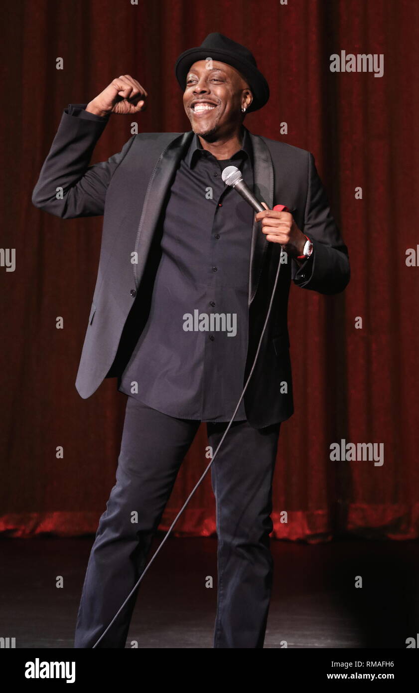 Comedian and talk show host Arsenio Hall is shown performing on stage during a 'live' concert appearance. Stock Photo