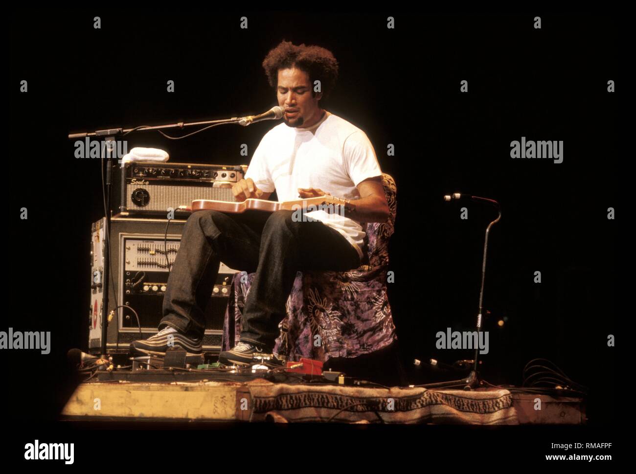 Musician Ben Harper is shown performing on stage during a "live"concert
