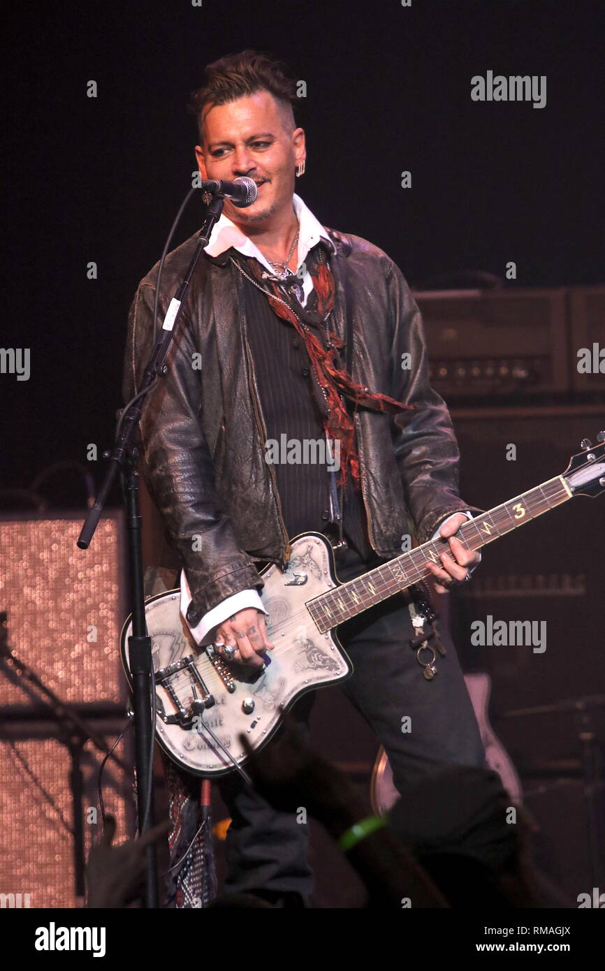 Actor and guitarist Johnny Depp is shown performing on stage during a 'live' concert appearance with the Hollywood Vampires. Stock Photo