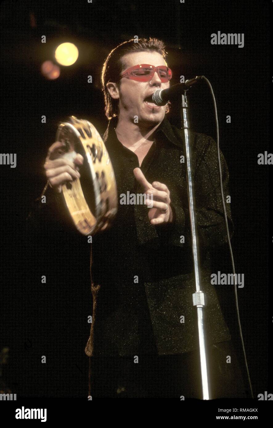 Frontman Ian Astbury of the Holy Barbarians is shown performing on stage during a concert appearance. Stock Photo