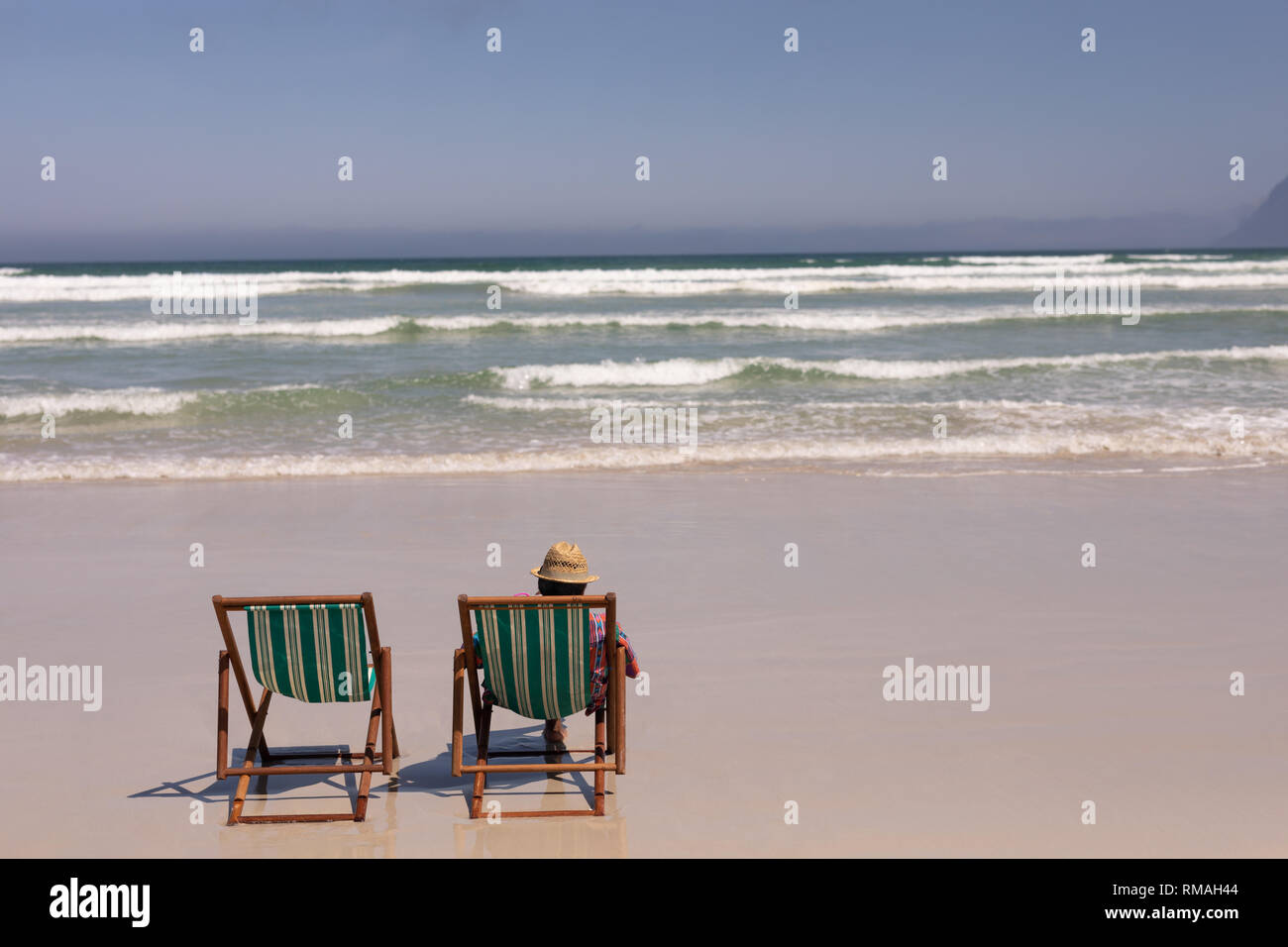 Senior man relaxing on sun lounger on beach Stock Photo - Alamy
