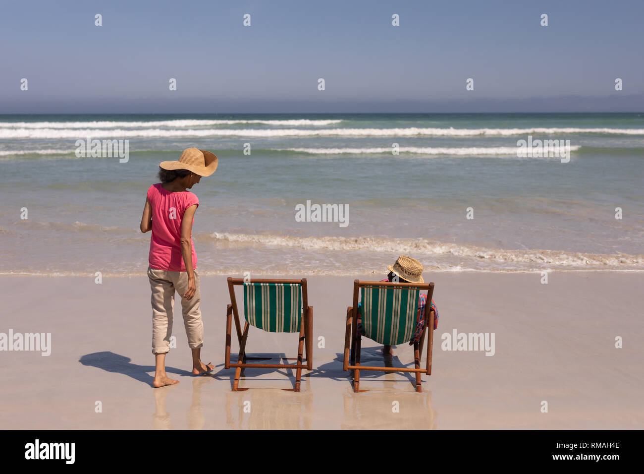 Senior couple relaxing on sun lounger on beach Stock Photo - Alamy