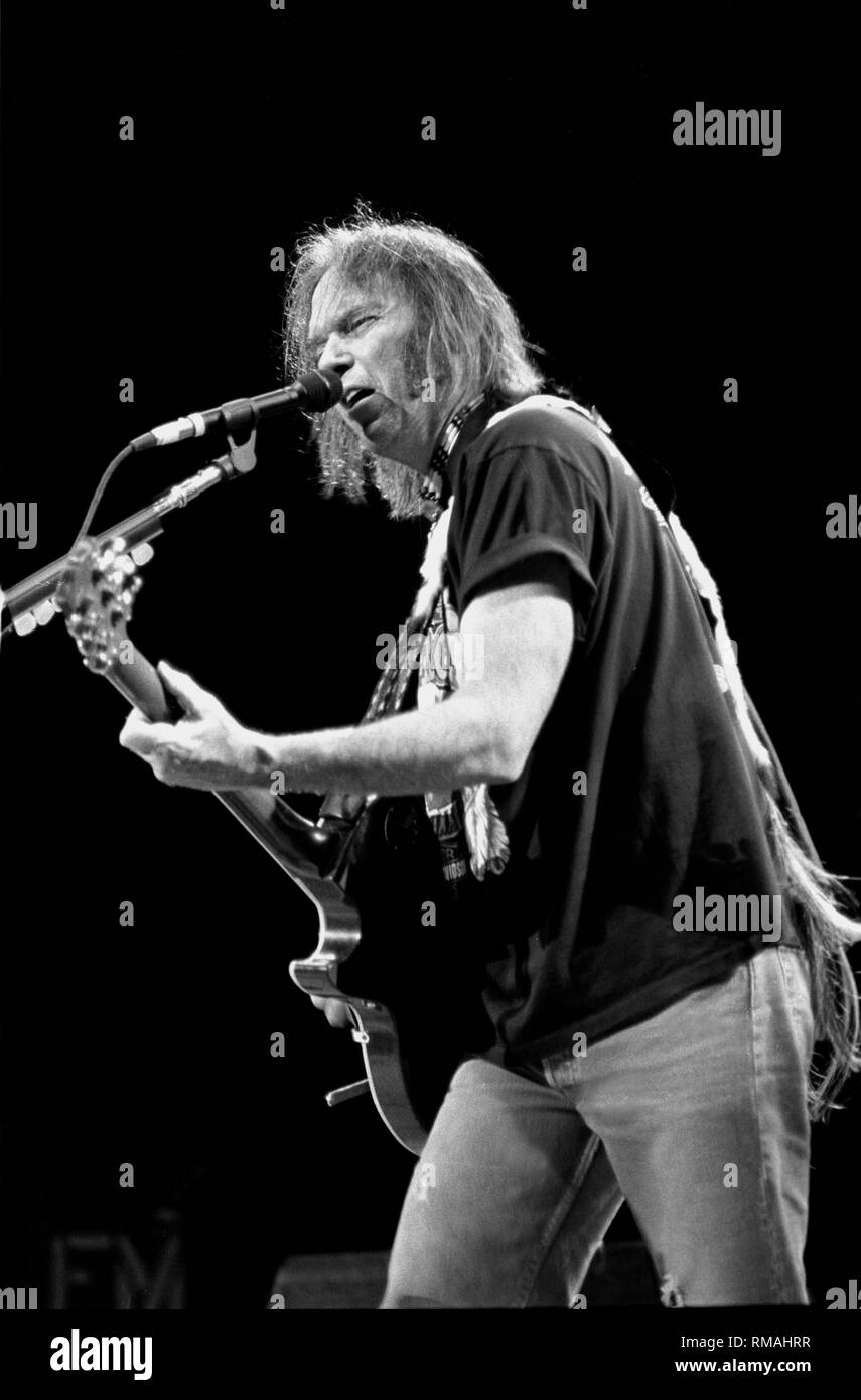 Singer, songwriter, and guitarist Neil Young is shown performing on stage during a 'live' concert appearance. Stock Photo