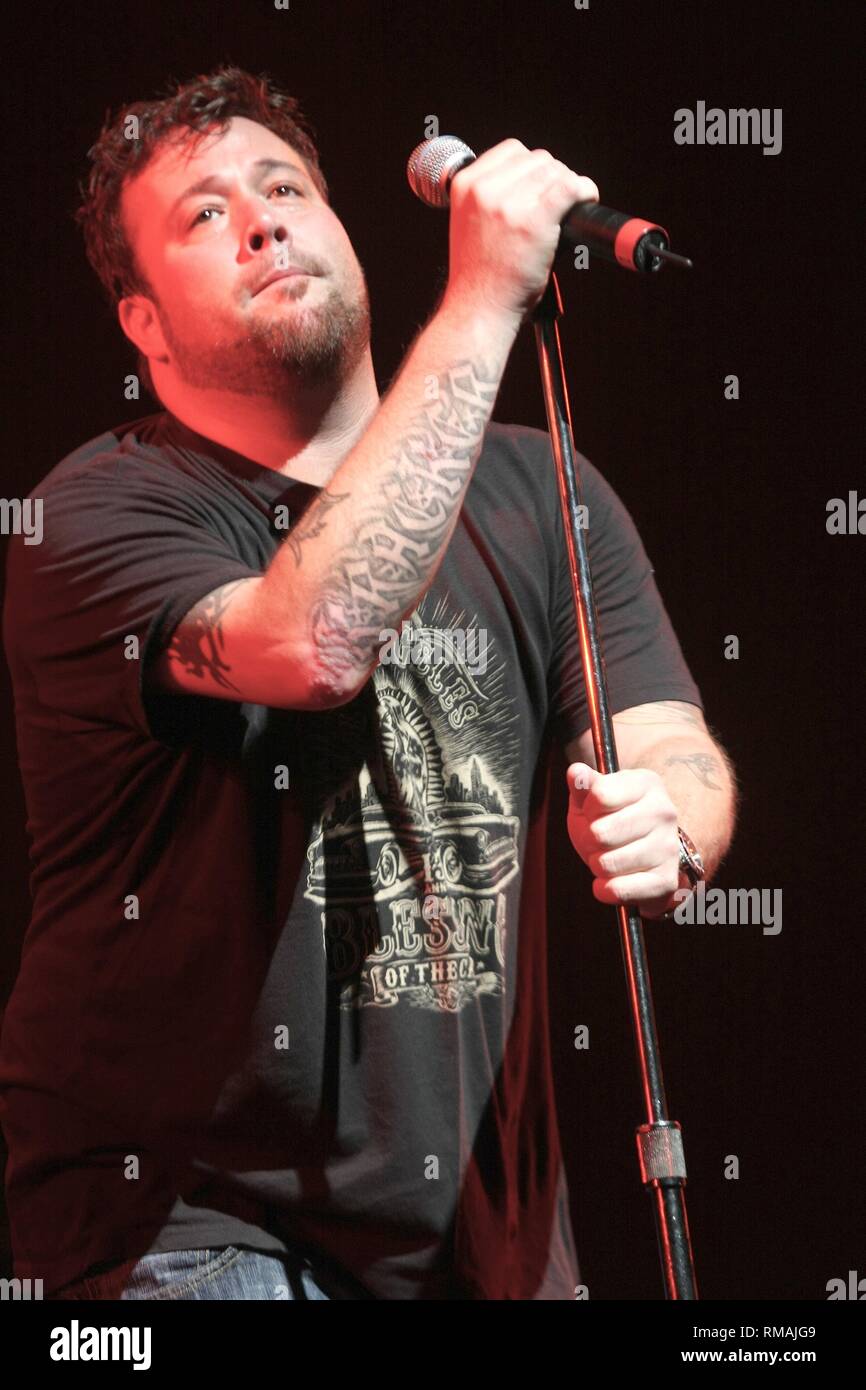 Uncle Kracker is shown performing on stage during a "live" concert