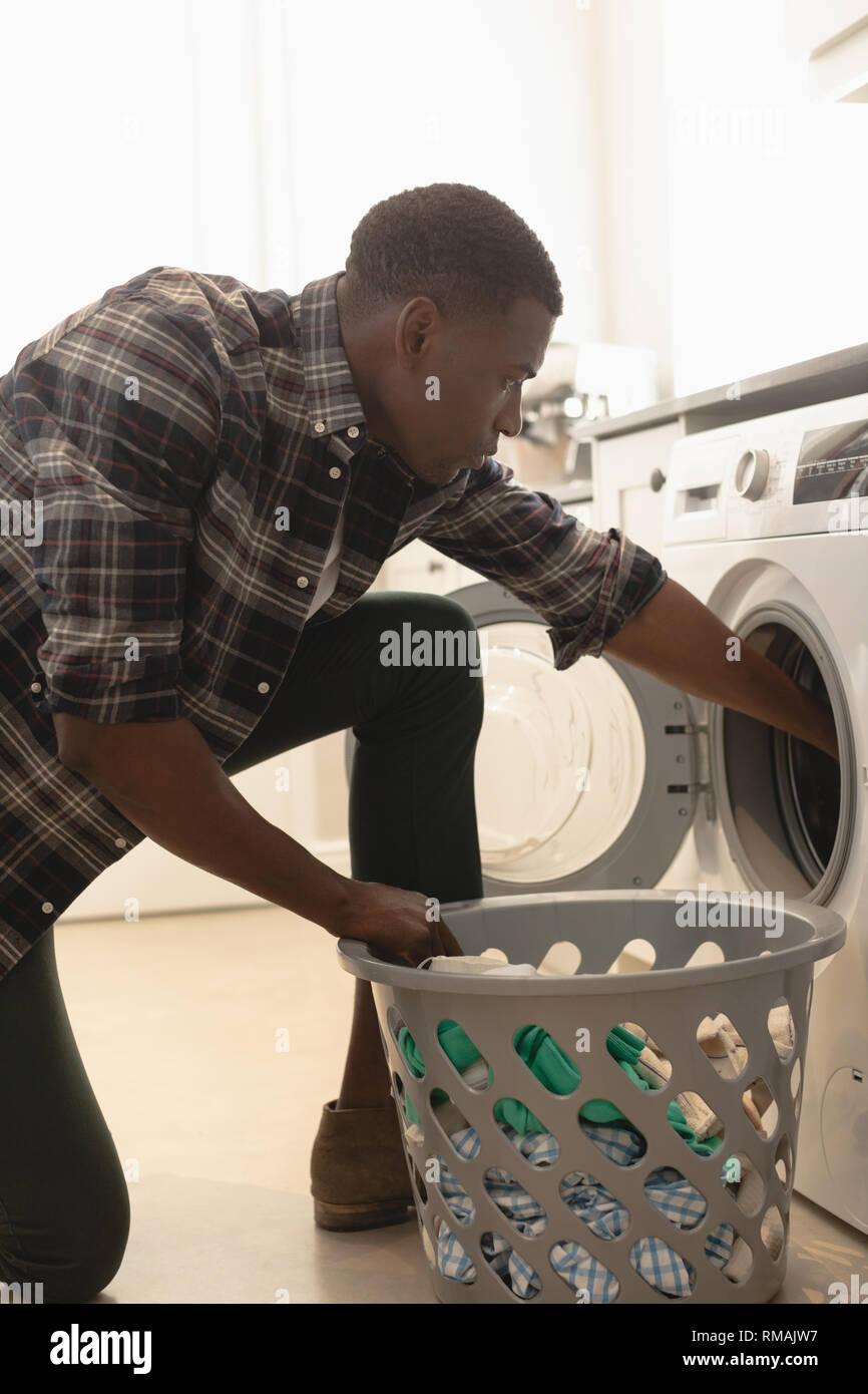 Dirty washing by washing machine hires stock photography and images