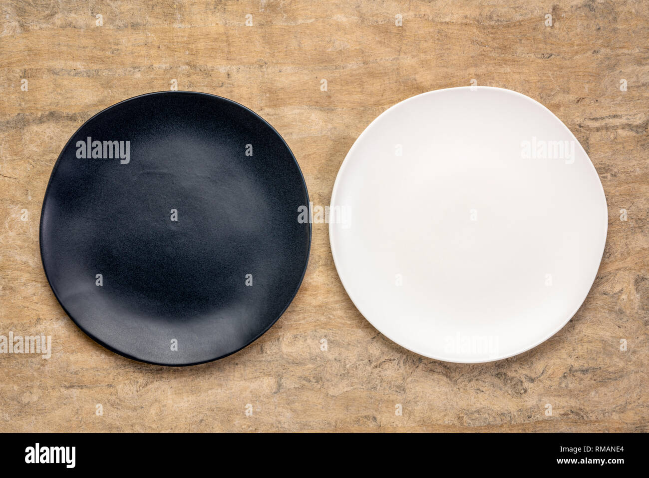 black and white ceramic plates with an irregular edge on a buckskin