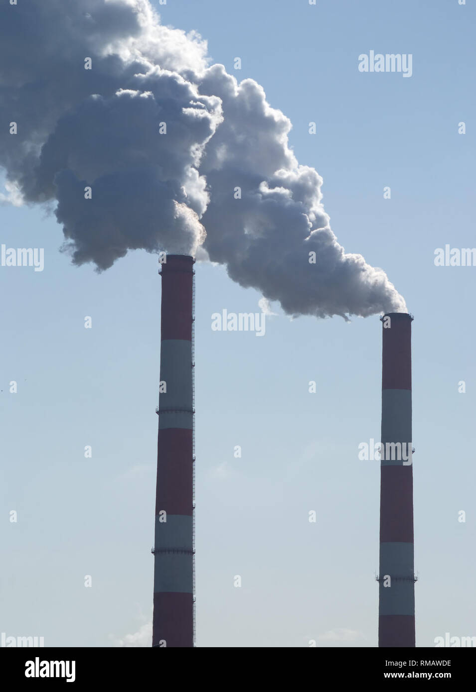 Two industrial long smoke pipes and lot of white steam Stock Photo - Alamy