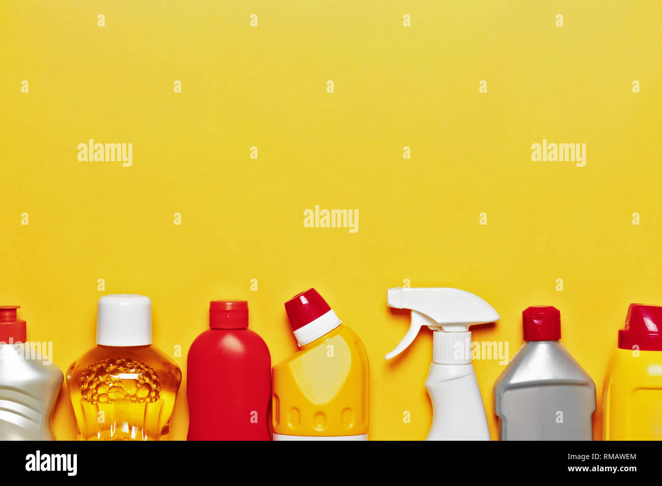 A variety of home cleaning products on a yellow background with copy space, top view Stock Photo