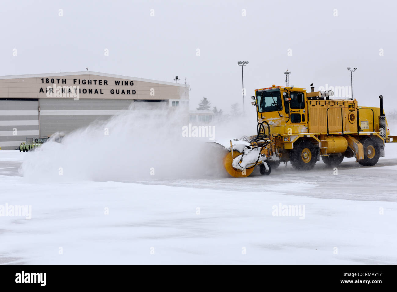 Heavy equipment removes snow and ice from the roads at the 180th Fighter Wing, Ohio Air National Guard during a polar vortex Jan. 28, 2019. Snow removal is a critical aspect of ensuring the 180FW can continue its mission, even in the worst weather conditions. (U.S. Air National Guard photo by Staff Sgt. Shane Hughes) Stock Photo