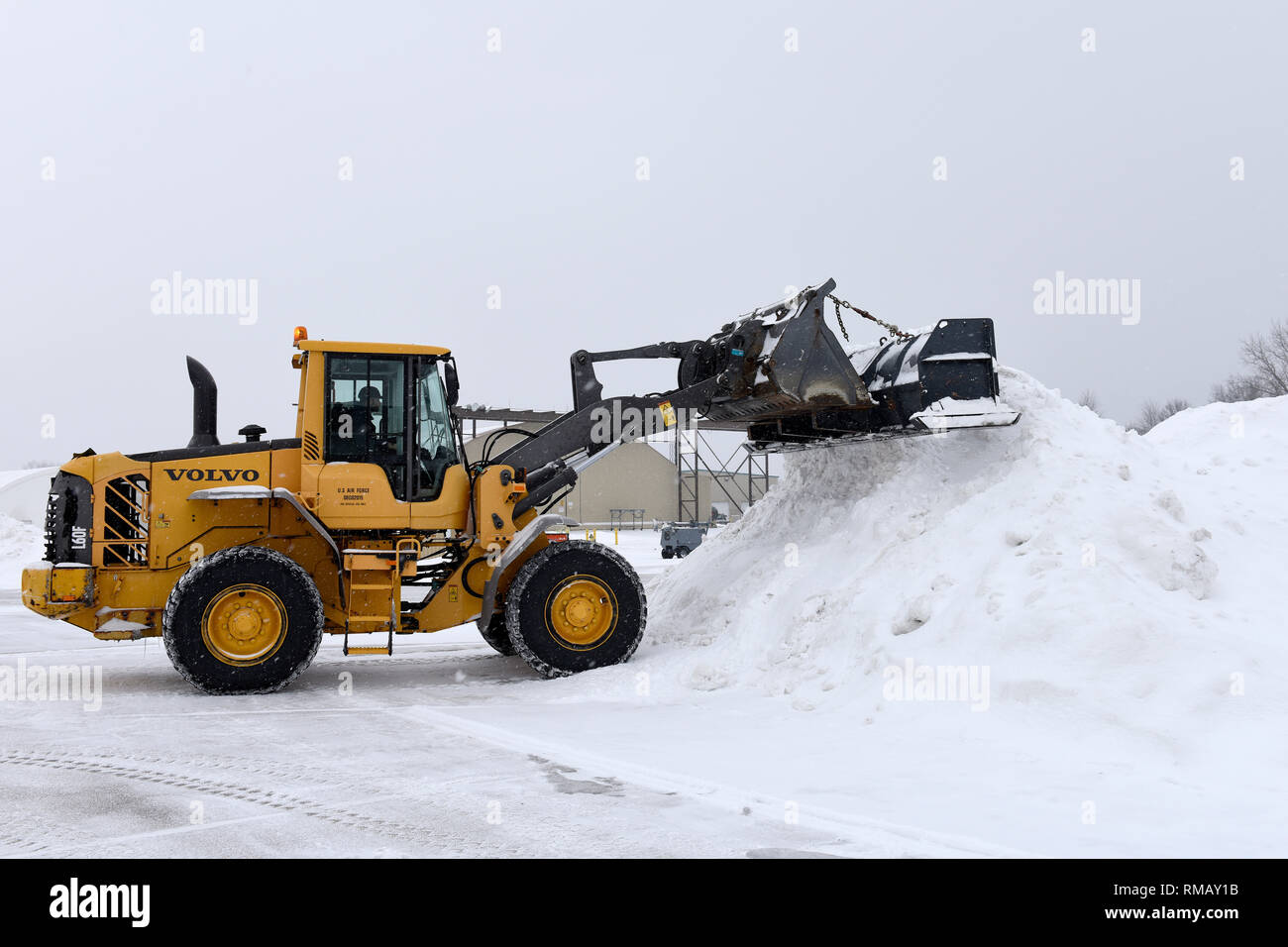 Heavy equipment removes snow and ice from the roads at the 180th Fighter Wing, Ohio Air National Guard during a polar vortex Jan. 28, 2019. Snow removal is a critical aspect of ensuring the 180FW homeland defense mission is always ready to respond to the nation's call. (U.S. Air National Guard photo by Staff Sgt. Shane Hughes) Stock Photo