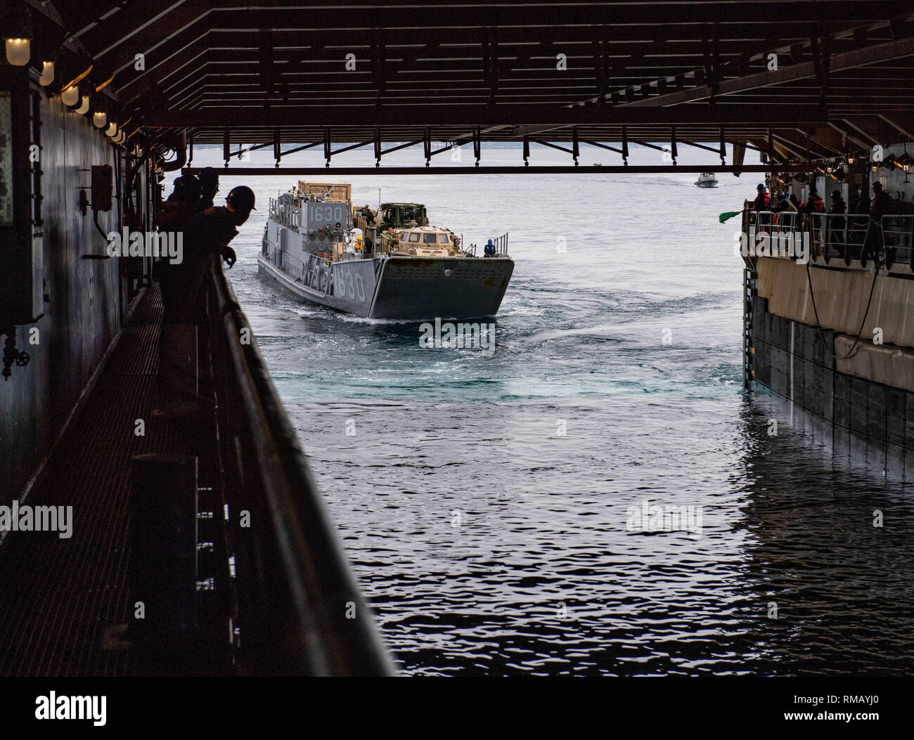 190212-N-HD110-0170  PACIFIC OCEAN (Feb. 12, 2019) Sailors observe Landing Craft, Utility 1630 assigned to Assault Craft Unit (ACU) 1 enter the well deck of the Harpers Ferry-class amphibious dock landing ship USS Harpers Ferry (LSD 49). Harpers Ferry is underway conducting routine operations as a part of USS Boxer Amphibious Ready Group (ARG) in the eastern Pacific Ocean. (U.S. Navy photo by Mass Communication Specialist 3rd Class Danielle A. Baker) Stock Photo