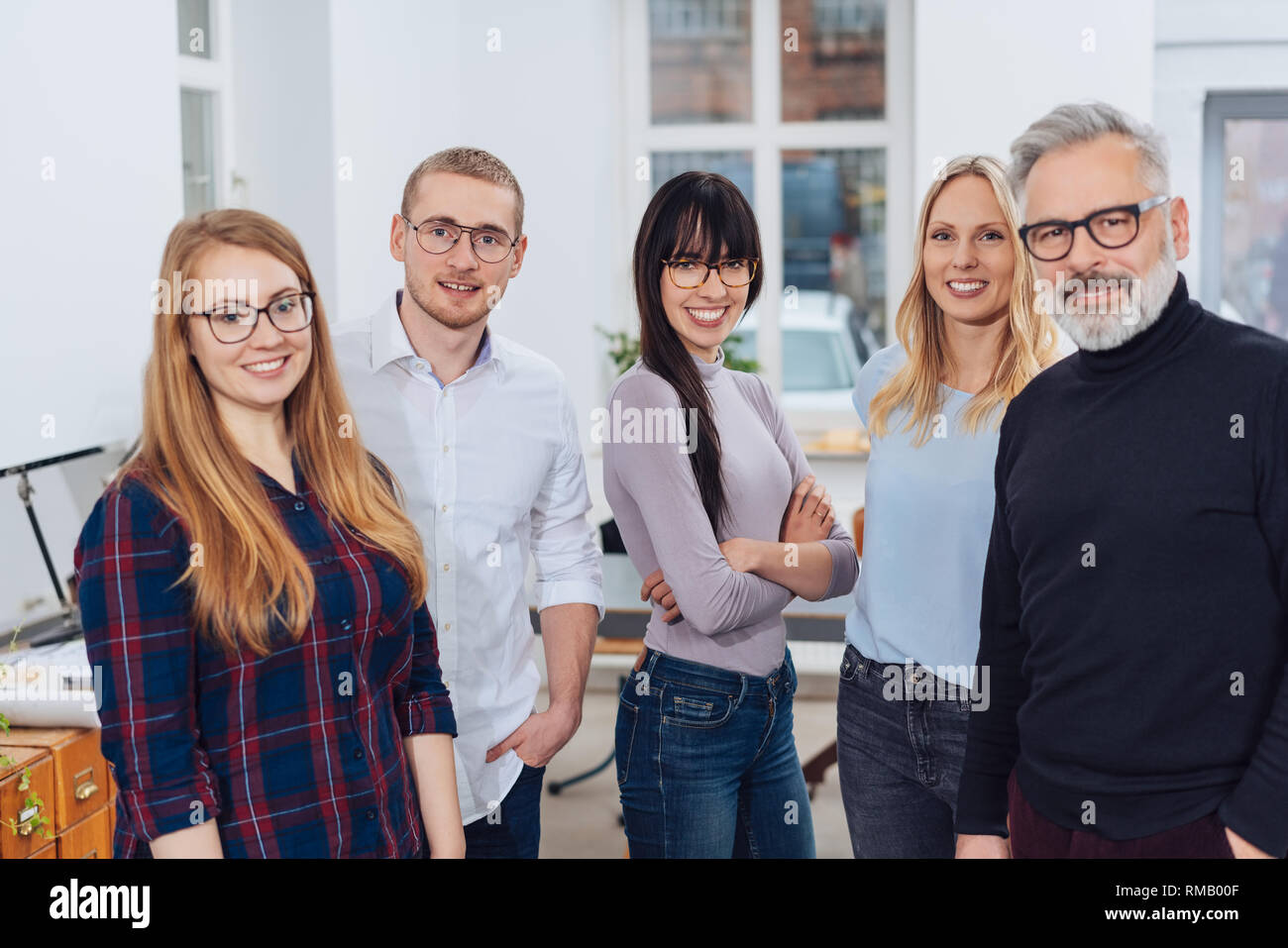 Group Photo Of Team Of Colleagues In Office With Young Women