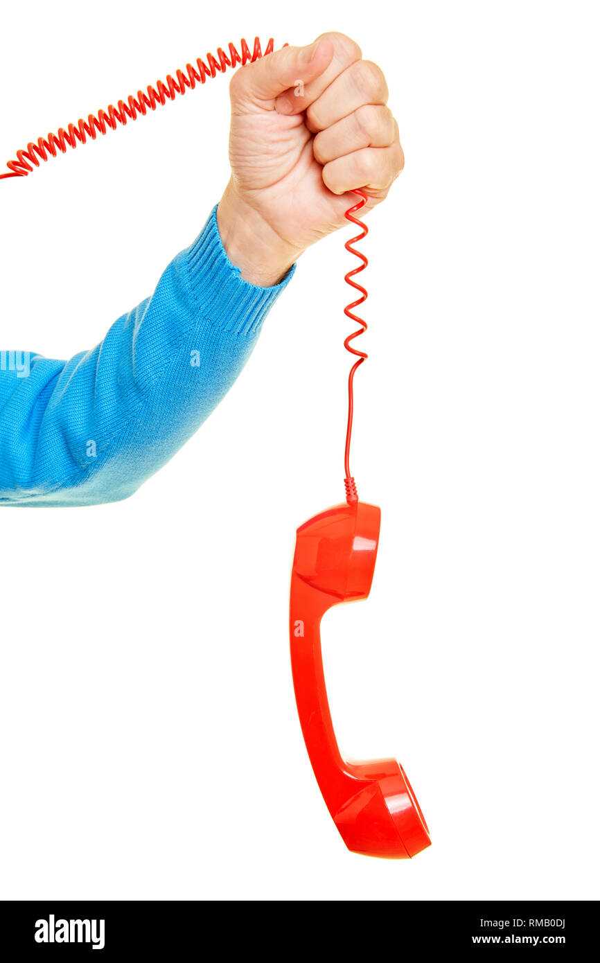 Male hand is holding a red telephone receiver on the cable Stock Photo