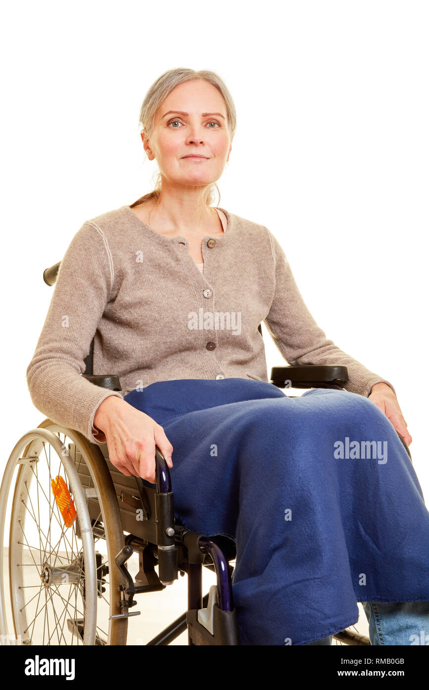 Smiling elderly woman is sitting in wheelchair Stock Photo