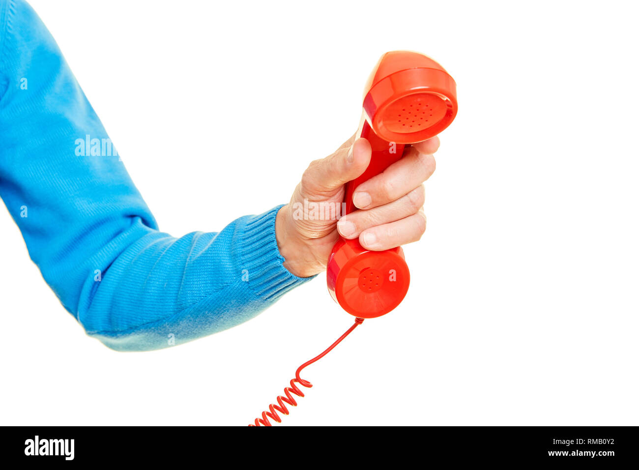 Male hand is holding a red phone as an emergency call concept Stock Photo