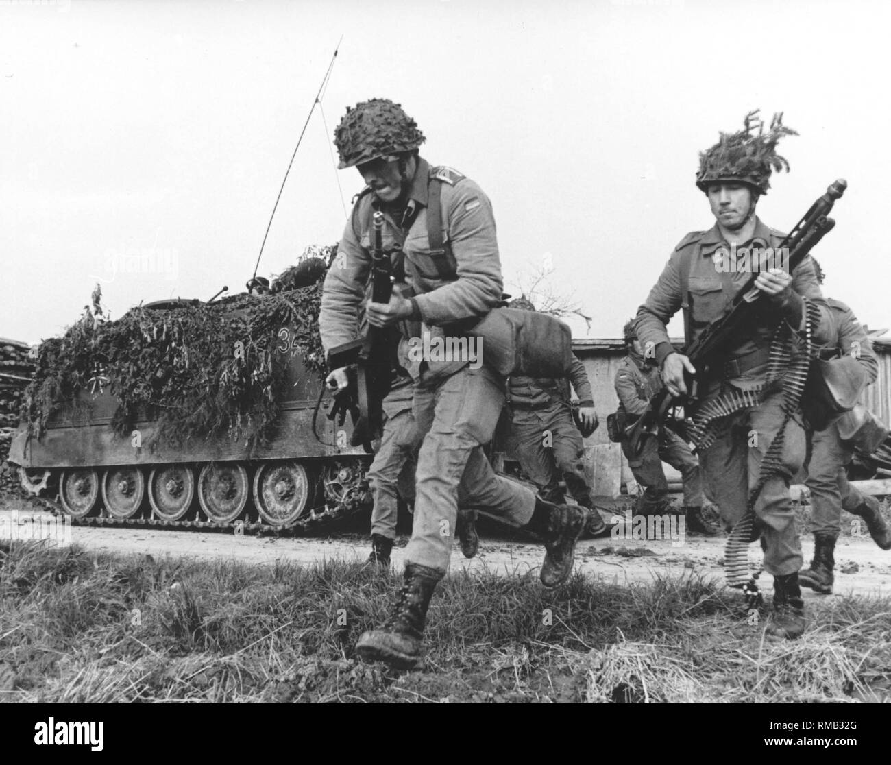Armored infantrymen leave their M-113 transporter. Stock Photo