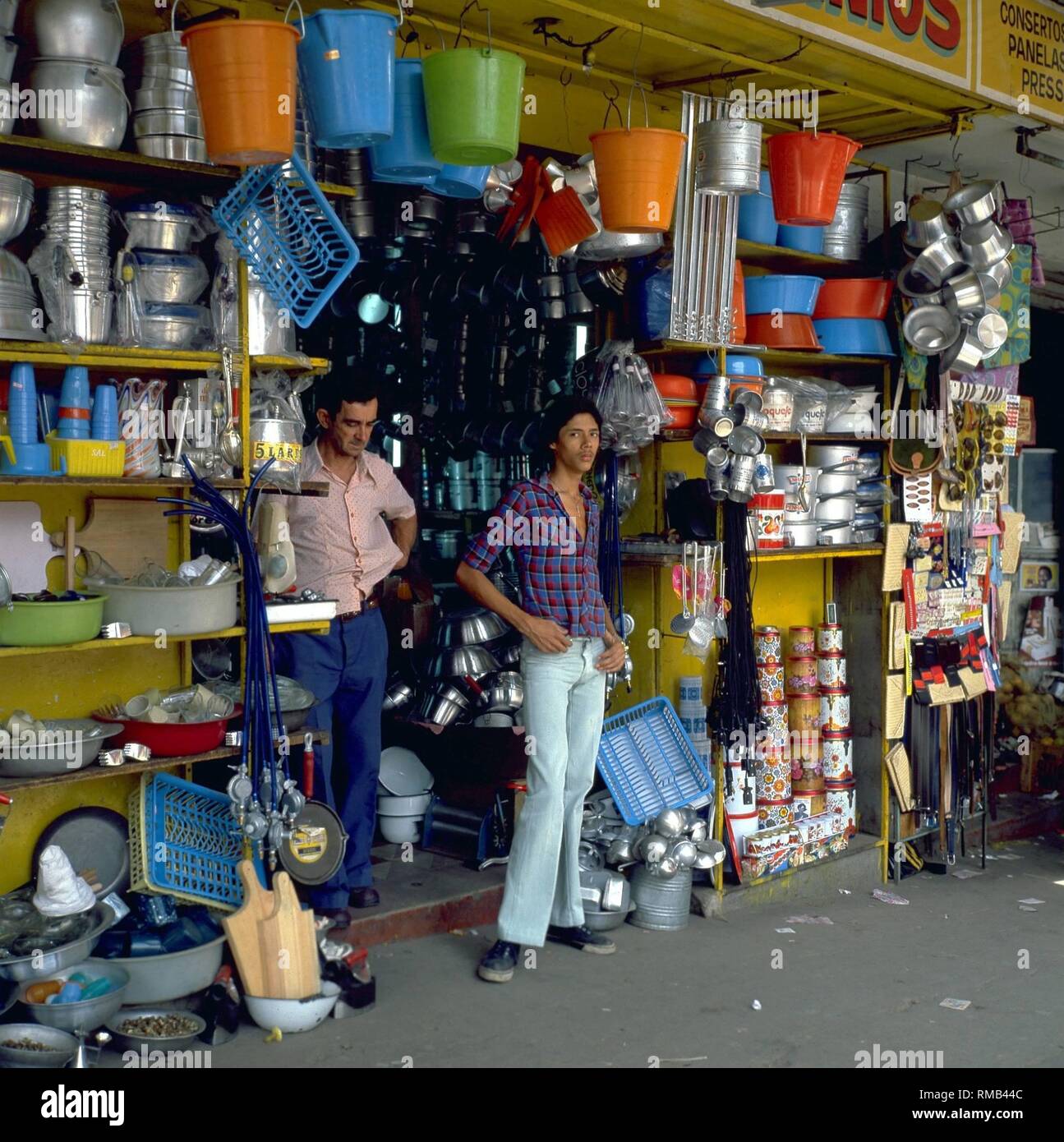 Men in front of a store with household goods in Belo Horizonte. Stock Photo