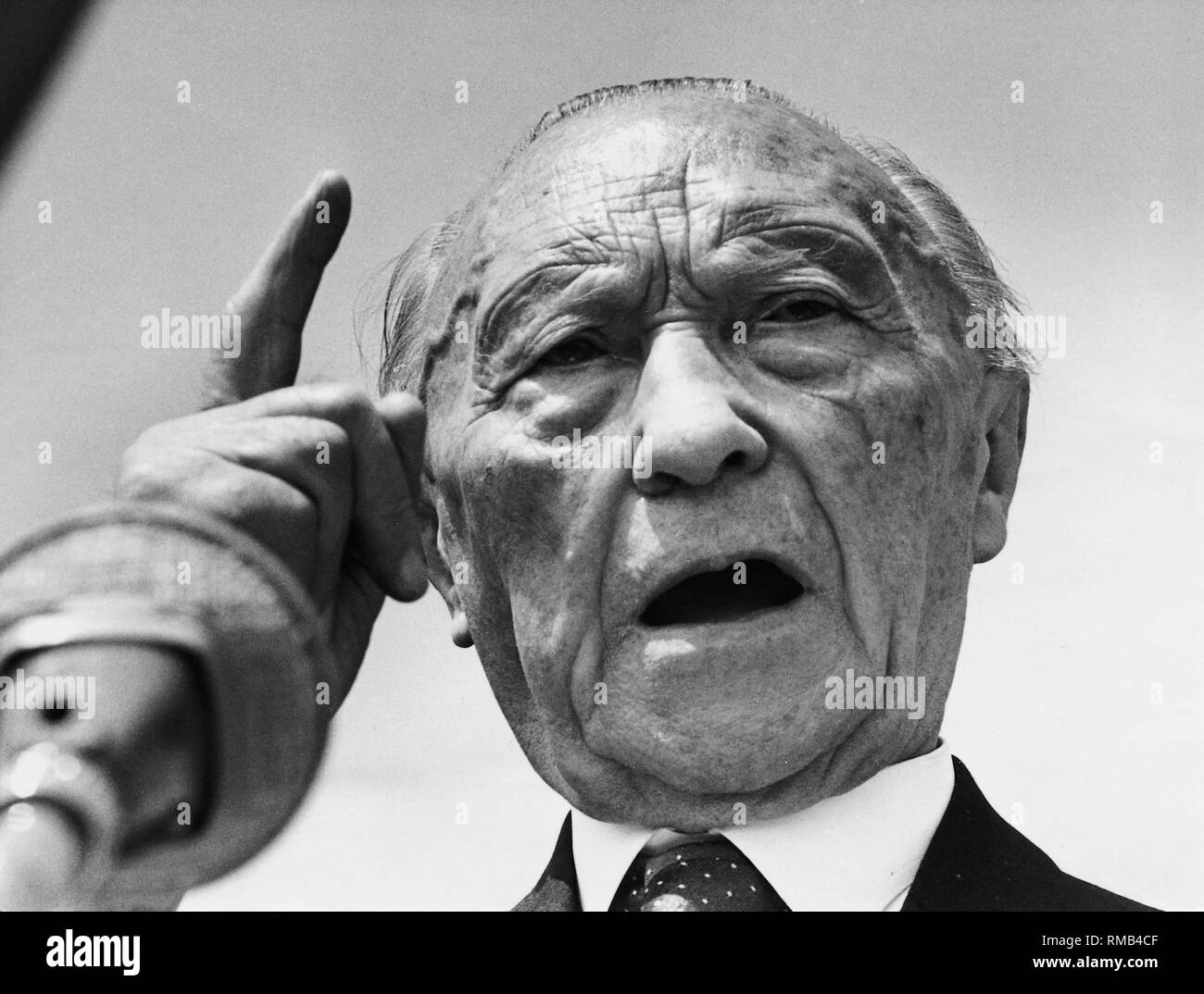 Chancellor Konrad Adenauer speaks in a microphone. Stock Photo