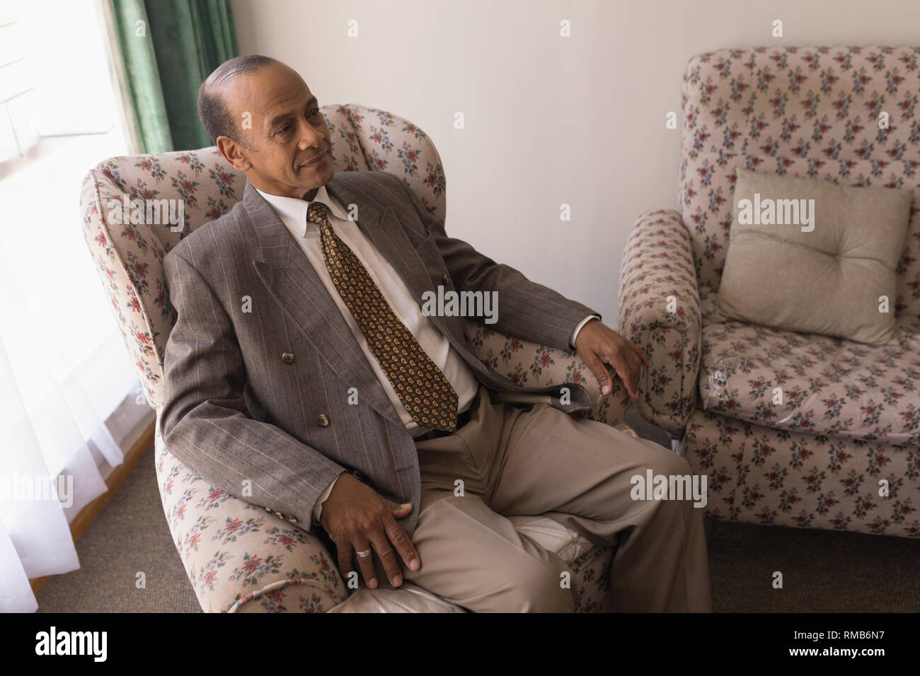 Senior man sitting couch hi-res stock photography and images - Alamy