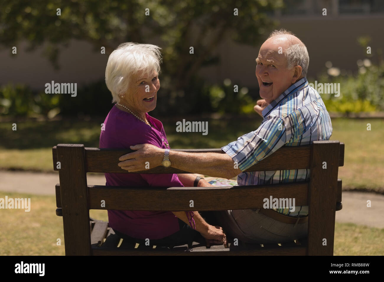 Senior couple sitting together on the bench in the park Stock Photo - Alamy