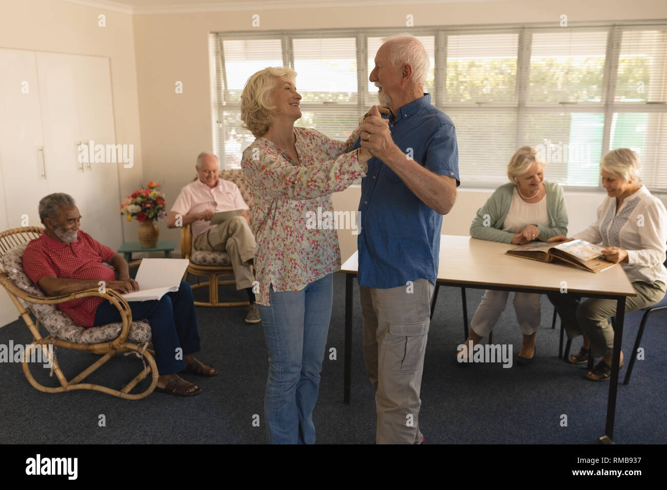 Active senior couple dancing at nursing home Stock Photo