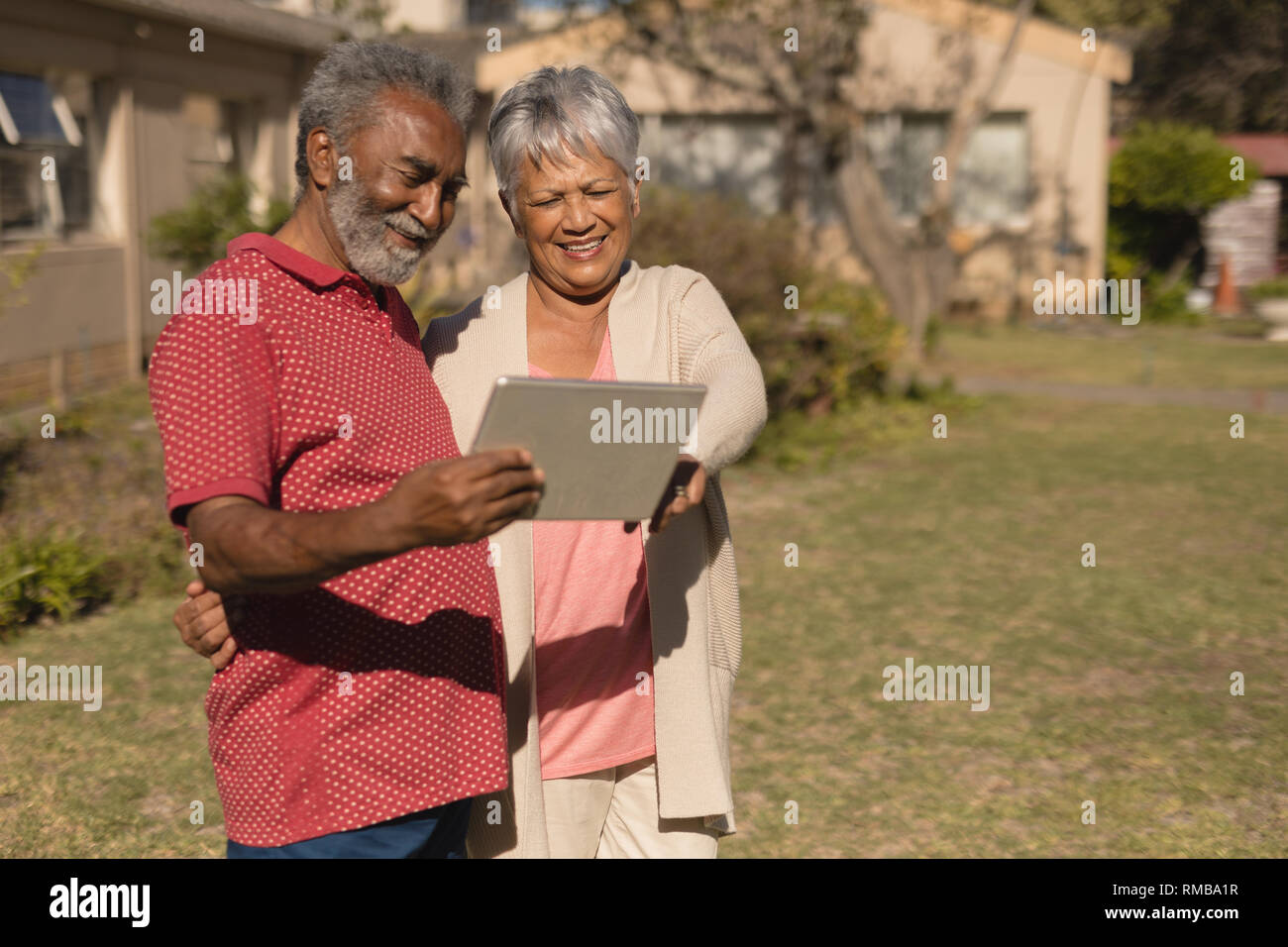 Senior couple using digital tablet in the park Stock Photo