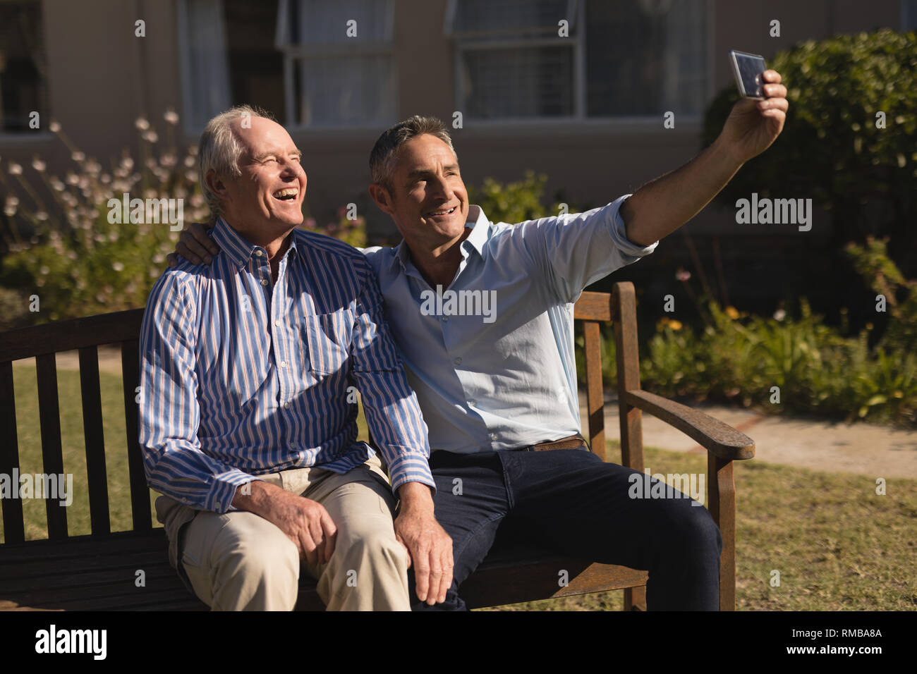 Senior men taking selfie with mobile phone in the park Stock Photo