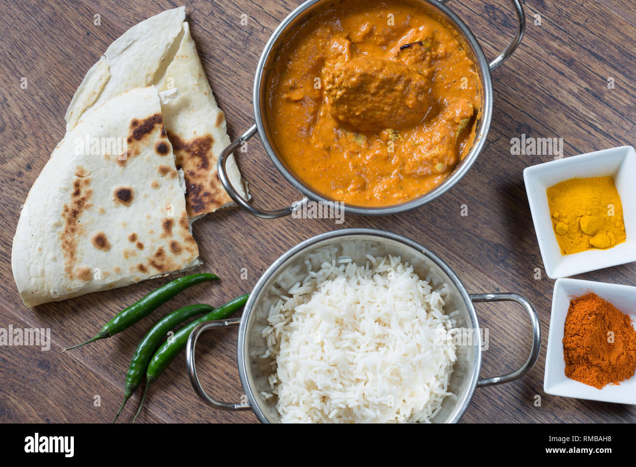 Popular Indian dish of Chicken tikka masala with boiled rice and naan  breads Stock Photo - Alamy