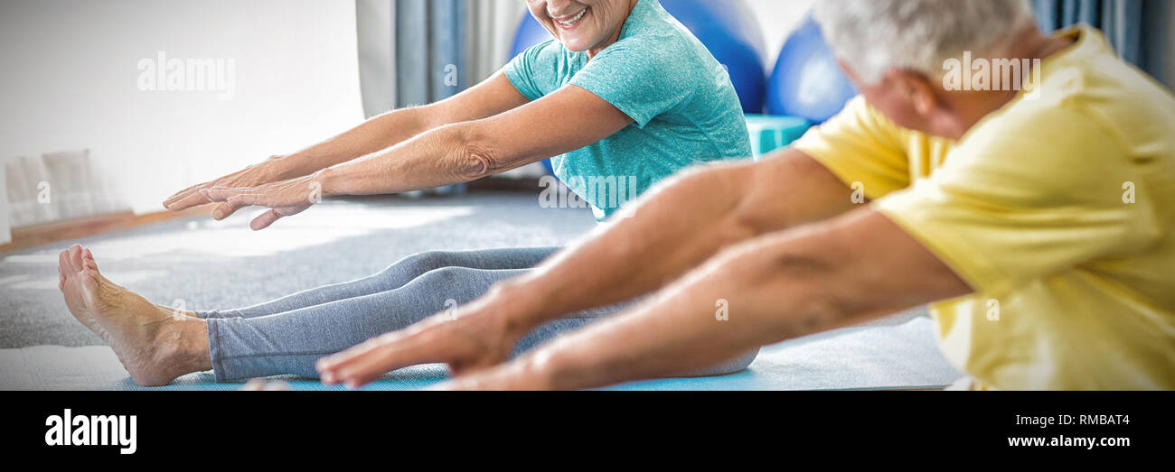 Seniors stretching legs Stock Photo