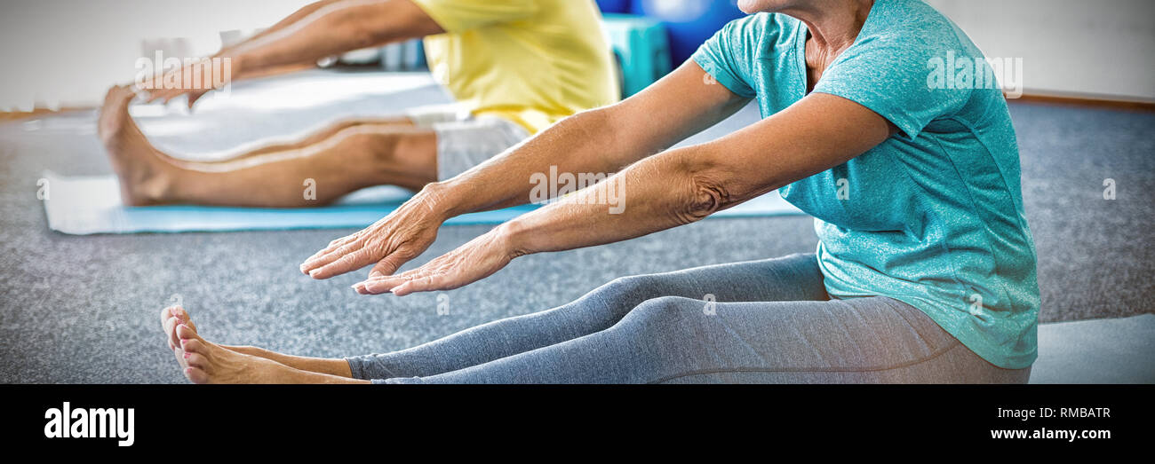 Seniors stretching legs Stock Photo