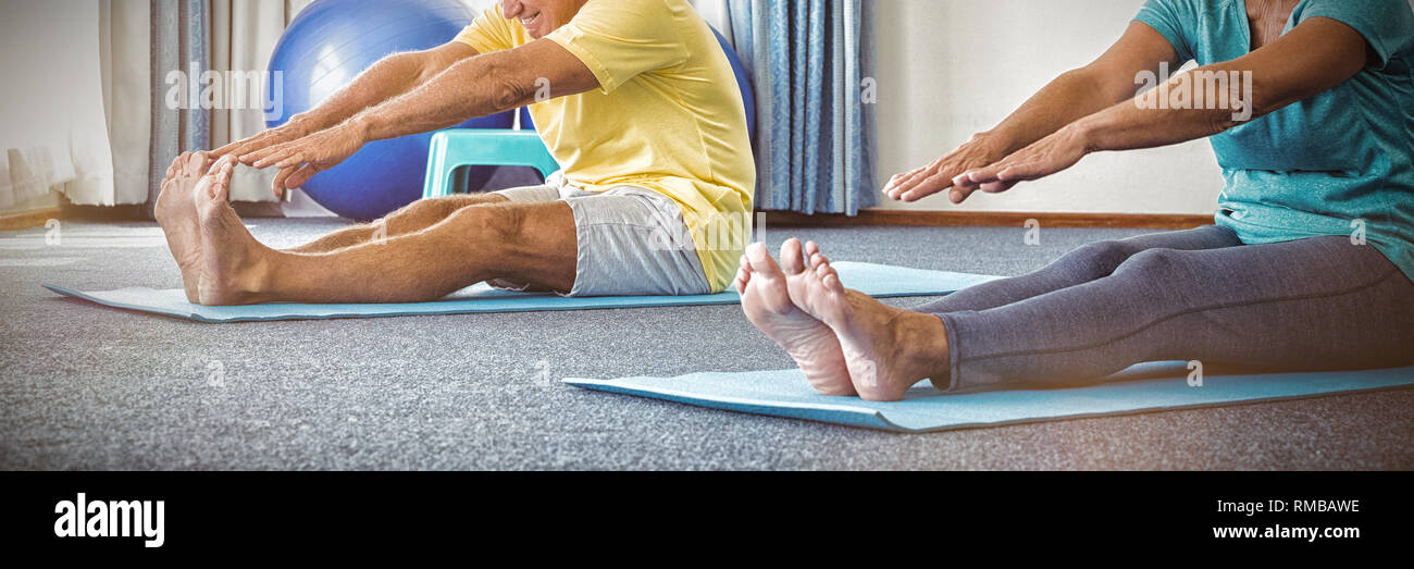 Side view of seniors doing exercises Stock Photo