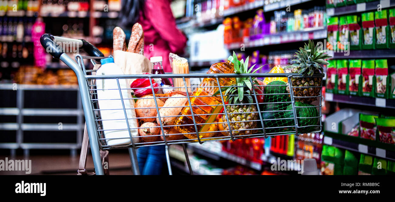 Various groceries in shopping cart Stock Photo