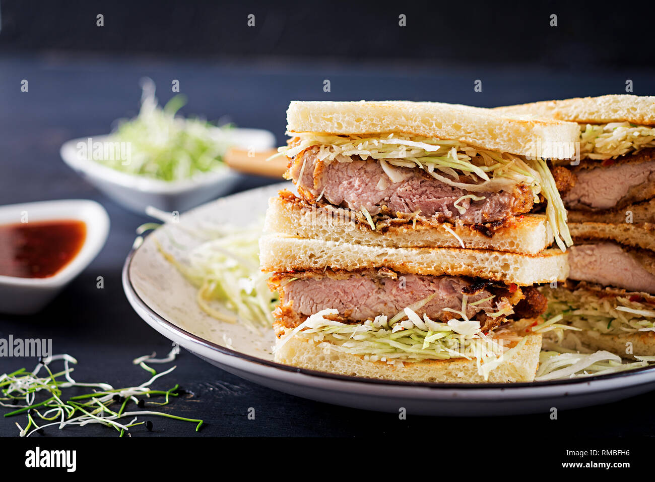 Katsu Sando - food trend japanese sandwich with breaded pork chop, cabbage and tonkatsu sauce. Japanese cuisine. Stock Photo