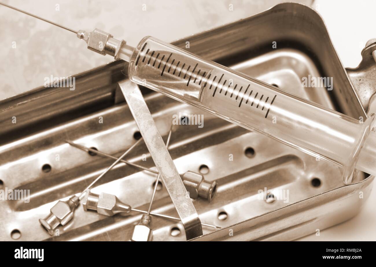 niddles and syringe in glass material with vintage old toned sepia effect Stock Photo