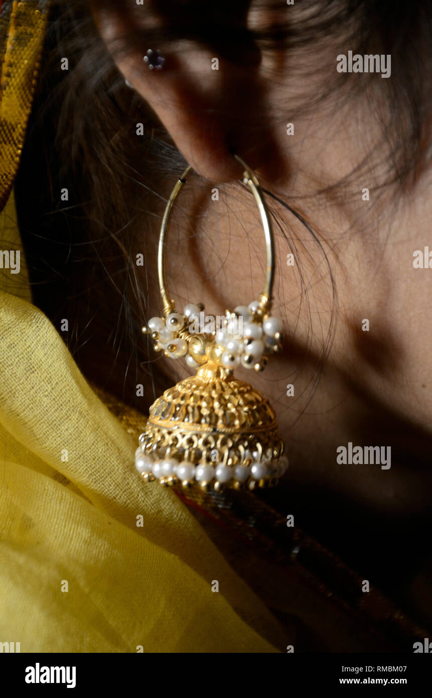 Indian woman wearing gold earrings hi-res stock photography and images ...