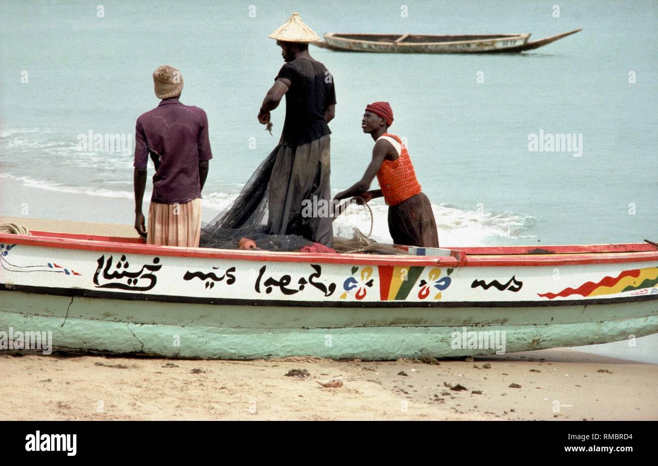 Fishermen with fishing boat in Senegal. Stock Photo