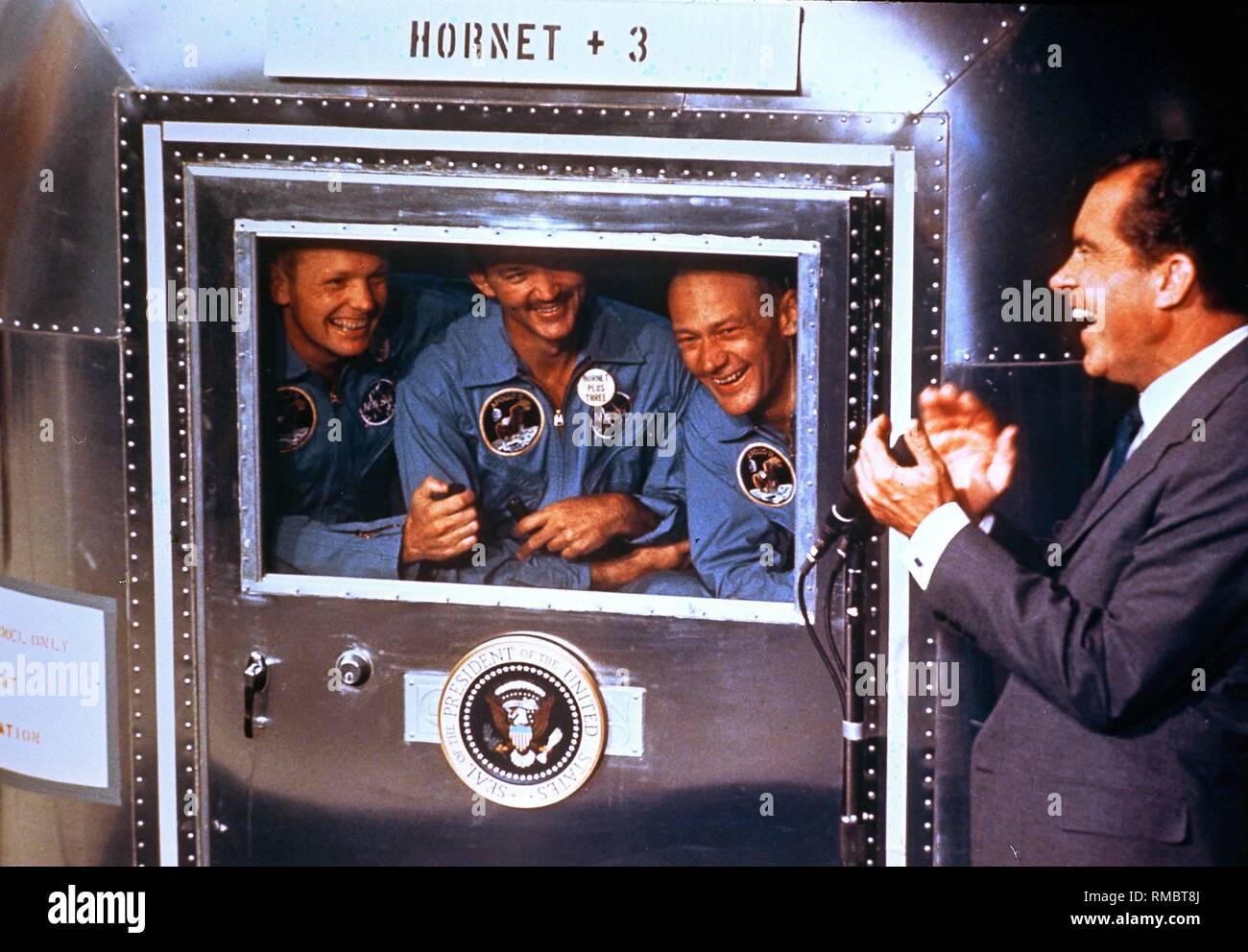 US-president Richard Nixon in conversation with the astronauts of the Apollo-11-mission, Neil A. Armstrong, Michael Collins and Edwin Aldrin in the recovery ship U.S.S. Hornet. After their return on the earth the astronauts have to be quarantined for three weeks. Stock Photo