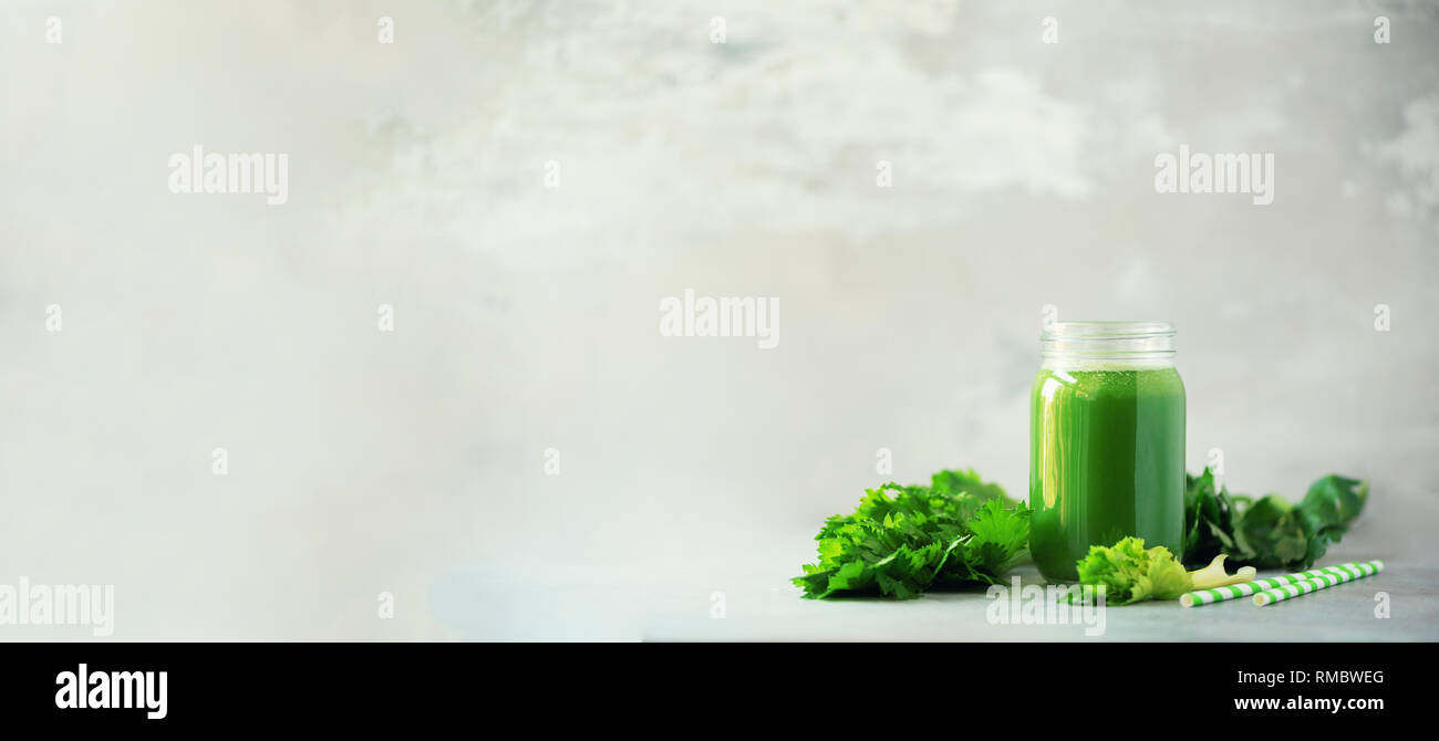 Bottle Of Green Celery Smoothie On Grey Concrete Background